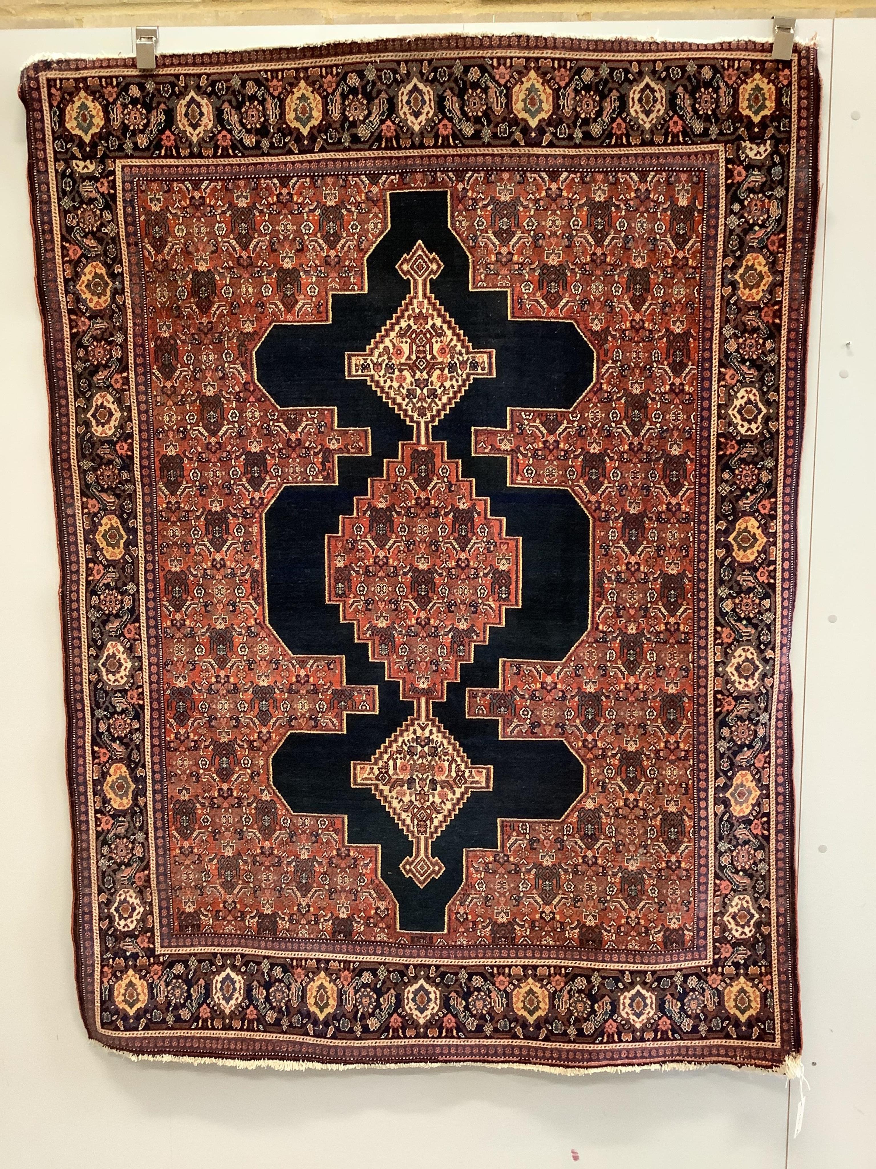 A Persian Senneh red ground rug, 186 x 138cm. Condition - fair to good